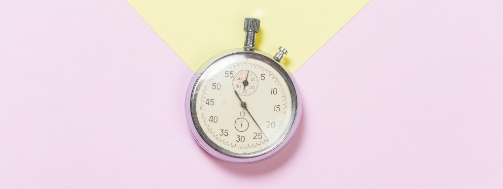 Old fashioned mechanical stopwatch on pastel background