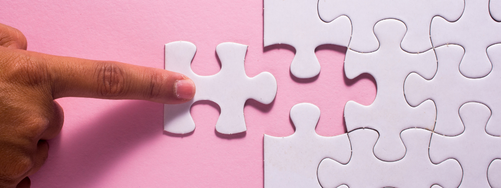 White puzzle pieces on pink background