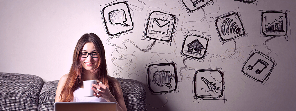 Woman sat on sofa drinking from a mug with app mural on the wall