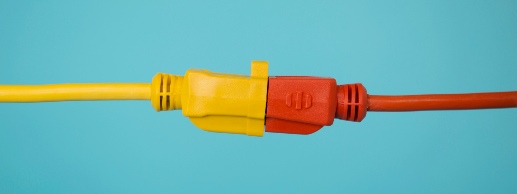 Yellow and Red ethernet cables connected together on a turquoise background